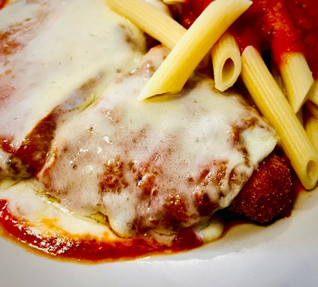 Chicken parmigiana with marinara and melted mozzarella at Frank's Pizza